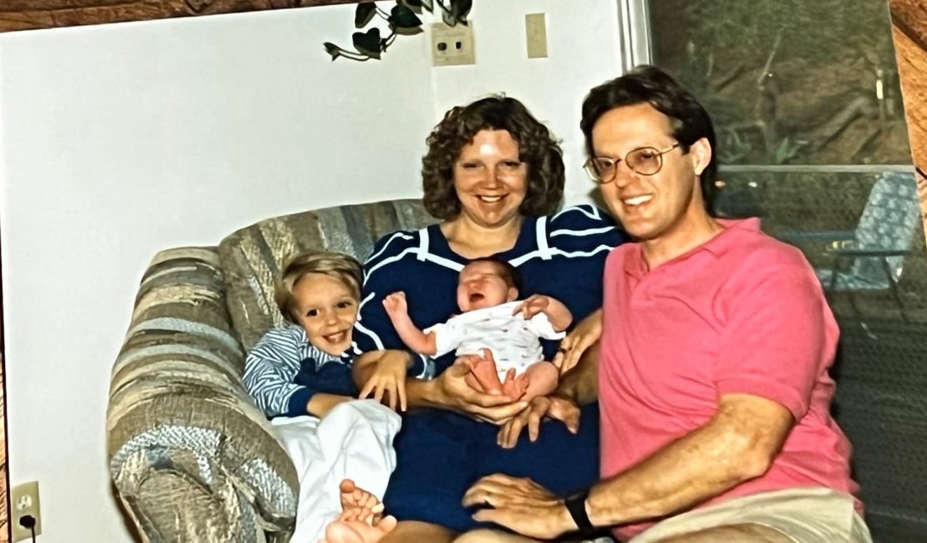 The Byars family on the couch with the brothers as small kids
