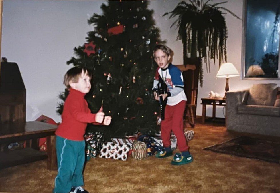 The Byars brothers as kids by the Christmas tree, one holding a toy guitar